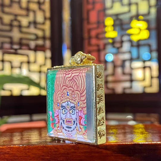 Side view of the Acala Vidyaraja Thangka Gau Pendant, showcasing the gold-plated copper casing and detailed craftsmanship.