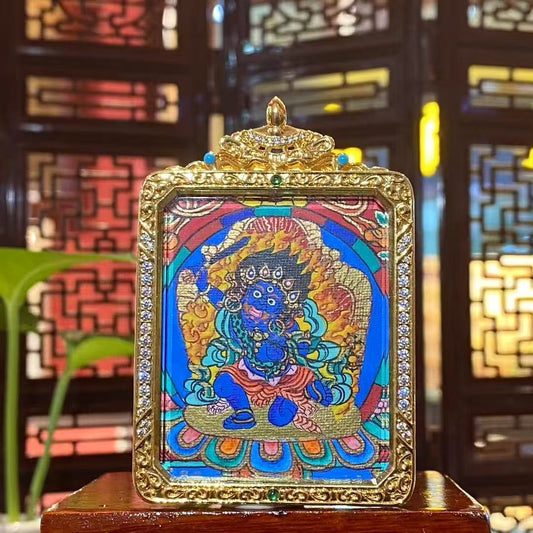 Hand-painted Acala Vidyaraja in wrathful blue form, holding the wisdom sword and surrounded by purifying flames, depicted on the front of a double-sided Tibetan thangka Gawu pendant