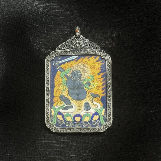 Front view of Acalanatha (Fudo Myo-o) mini thangka pendant, fully hand-painted with natural mineral pigments, set in a vintage-style silver case, Tibetan origin.