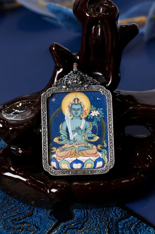 Front view of Akasagarbha Bodhisattva mini thangka pendant in a vintage silver case, Tibetan mineral pigment painting for wealth, wisdom, Virgo blessings, and Ox/Tiger protection.