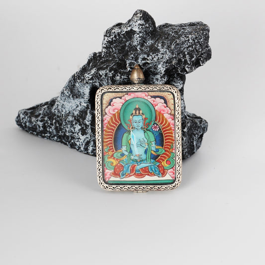Front view of the Akashagarbha Bodhisattva mini Thangka pendant, showing detailed mineral pigment painting, balanced iconographic proportions, and the framed silver gawu-style pendant structure.