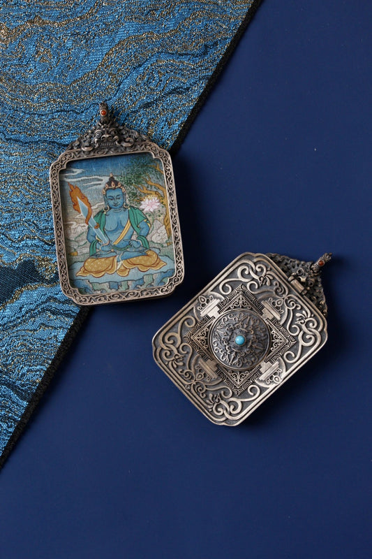 Front and back view of Akashagarbha Bodhisattva mini thangka pendant, hand-painted with mineral pigments and set in a vintage silver case, Tibetan origin