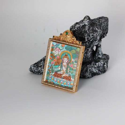 Side-angled product photo of an Akashagarbha Bodhisattva thangka pendant with a gold jeweled border and detailed traditional painting.