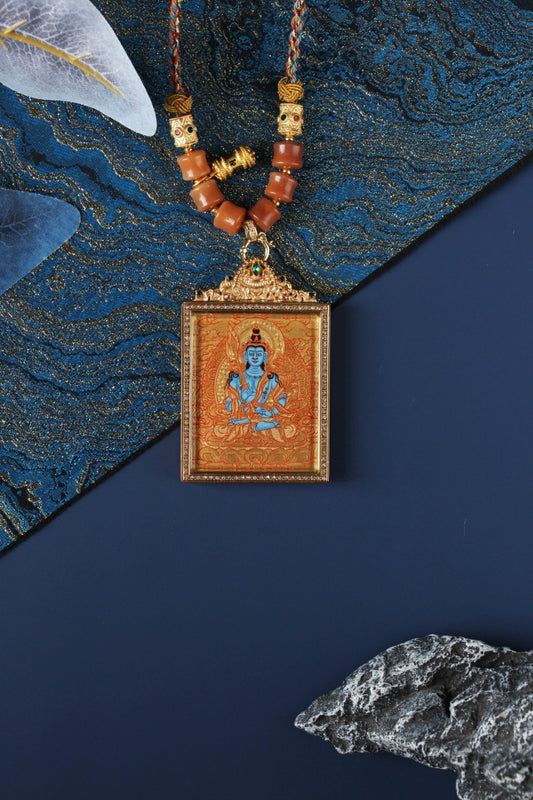 Hand-painted Akashagarbha Bodhisattva mini thangka pendant in Rebgong gold thangka style, featuring mineral pigment artwork, square double-sided titanium steel case, and ornate top bail with green gemstone detail