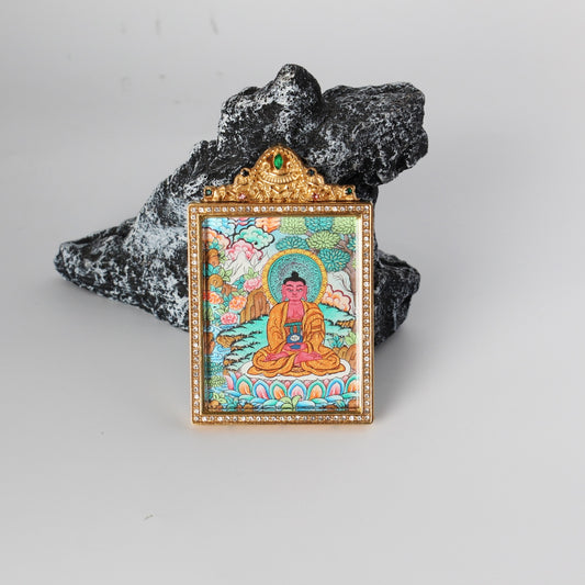 Front view of Amitabha Buddha mini thangka pendant, red Buddha figure seated on lotus base, hand-painted with mineral pigments, enclosed in a gold-tone double-sided jewelry-grade titanium steel case with crystal-style border