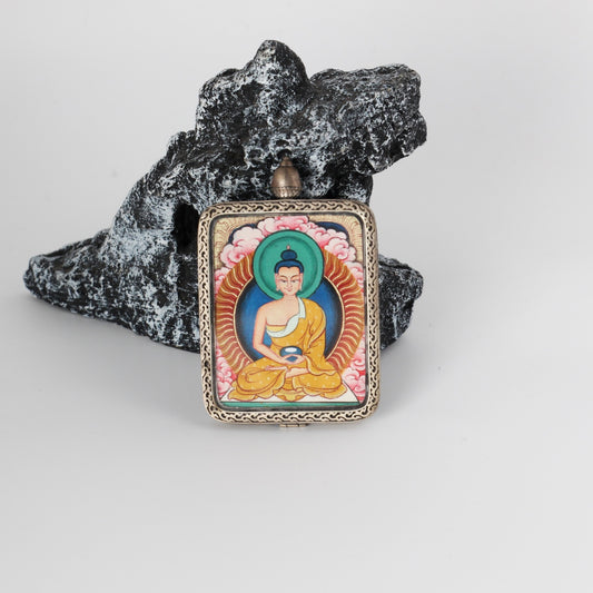 Front view of Amitabha Buddha mini Thangka pendant, hand-painted with mineral pigments, featuring a turquoise-green halo, golden robe details, and an engraved pure silver frame.
