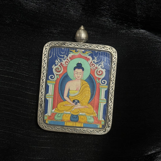 Close-up view of hand-painted Amitabha Buddha Thangka pendant showing mineral pigment layers and traditional Tibetan iconography