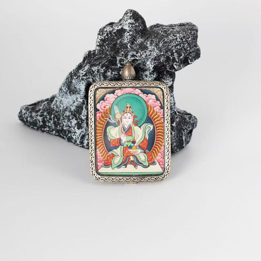 Front view of Bai Lhamo mini Thangka pendant, hand-painted with mineral pigments, mounted in a pure silver case with traditional Tibetan decorative patterns.