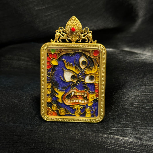 Front view of Black Jambhala cloisonné enamel mini thangka pendant featuring wrathful wealth deity face design with deep blue enamel background and 24K gold-plated copper frame