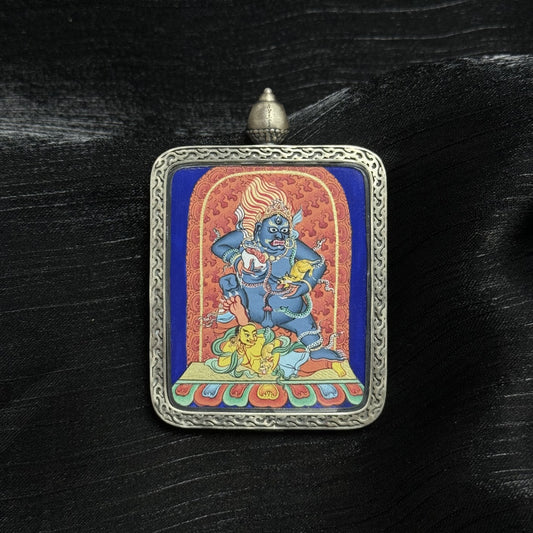 Front view of Black Jambhala mini thangka pendant, hand-painted Tibetan wealth deity artwork in silver Dunhuang Nine-Colored Deer case, 4x5 cm.