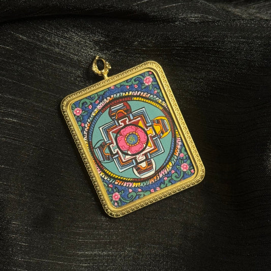 Angled view of hand-painted Buddhist mandala mini thangka pendant featuring colorful geometric mandala artwork mounted in a titanium steel pendant frame