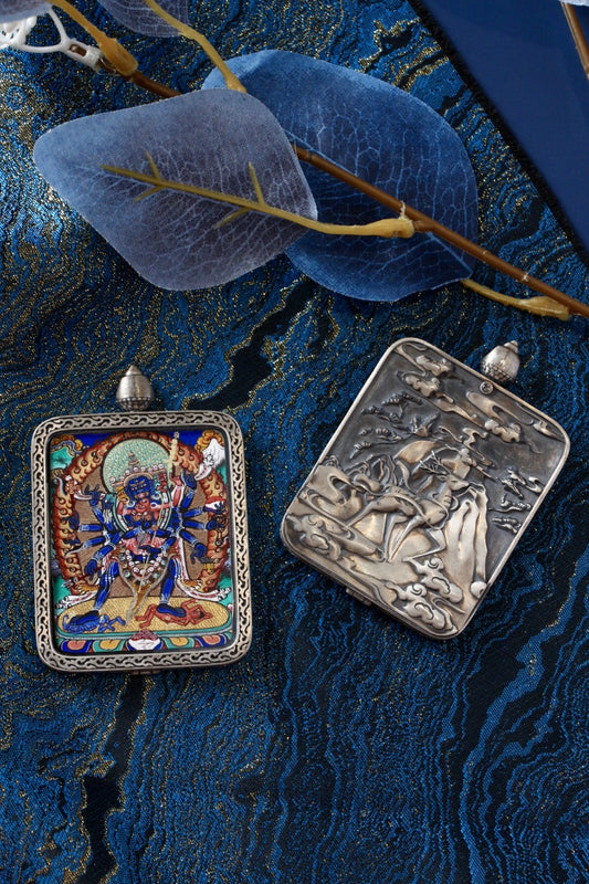 Front and back display of a Cakrasamvara mini thangka pendant, featuring a hand-painted Tibetan thangka on the front and an engraved silver back inspired by traditional Dunhuang motifs.