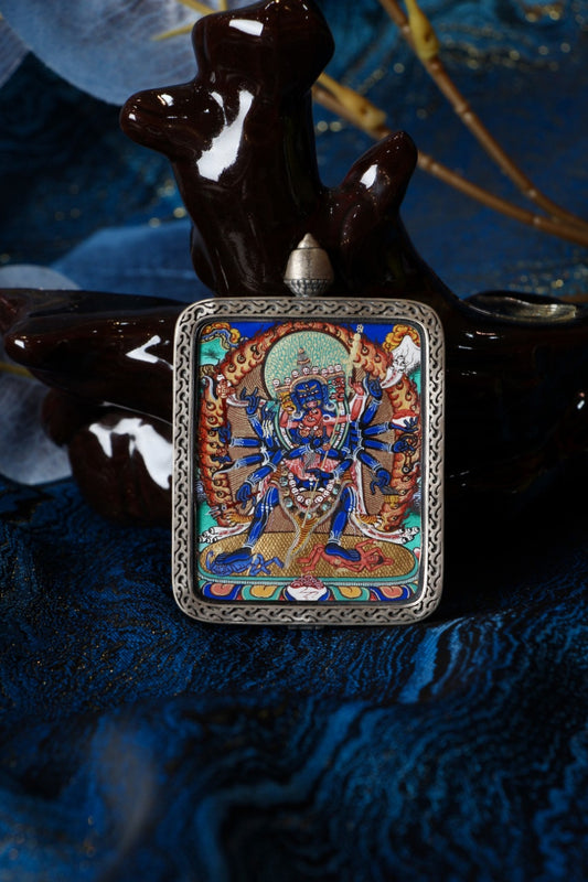 Front view of a Cakrasamvara mini thangka pendant, hand-painted with mineral pigments in the Rebgong Tibetan style, set in a pure silver pendant case for devotional and collectible use.