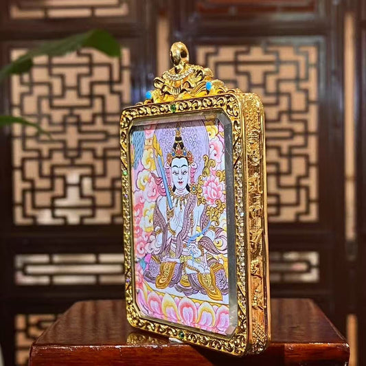 Side view of gold-plated copper Tibetan Gawu box containing a double-sided hand-painted Akashagarbha Bodhisattva and Four-Directional Mandala thangka