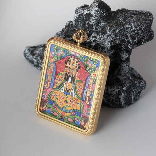 Angled front view of Dragon Fifth Lord (Long Wuye) mini thangka pendant with hand-painted seated figure, red throne backdrop, floral border details, and gold-tone titanium steel frame with patterned edge.