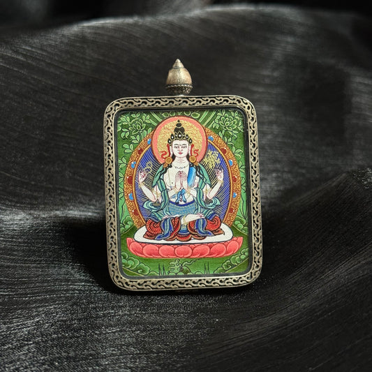 Close view of Four-Armed Avalokiteshvara mini thangka pendant highlighting detailed Tibetan hand-painted thangka art and ornate metal pendant frame