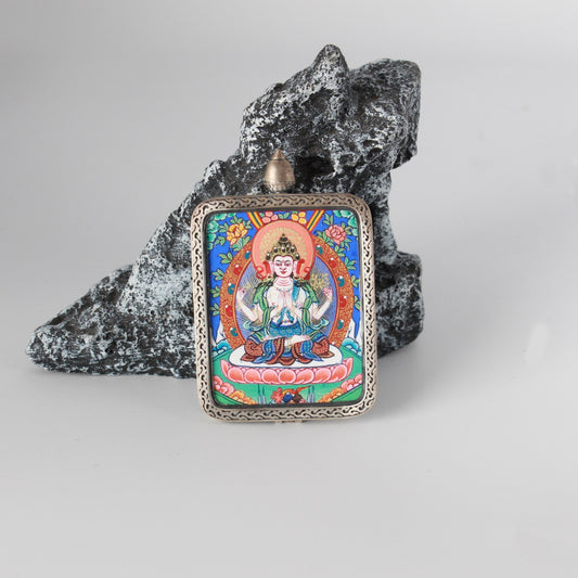 Front view of Four-Armed Avalokiteshvara mini thangka pendant, hand-painted with mineral pigments, set in a Dunhuang Nine-Colored Deer motif silver case with engraved border details