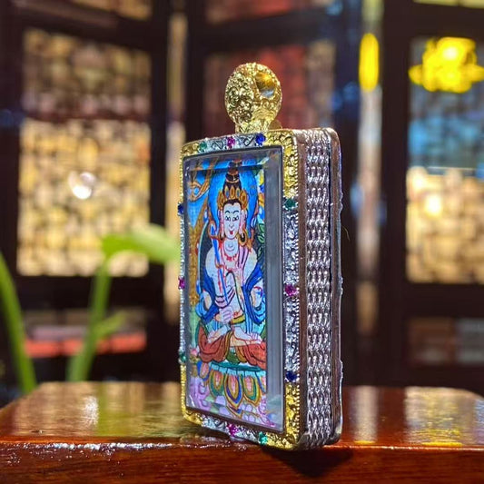Side view of gold-plated copper gau pendant housing a hand-painted Akashagarbha Bodhisattva thangka