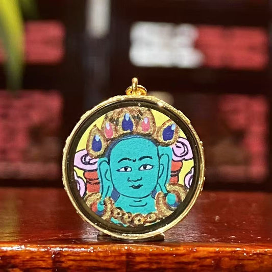 Front view of a mini Green Tara Thangka pendant, hand-painted with 18K gold in Rebgong tradition, depicting Green Tara in a refined and delicate form.