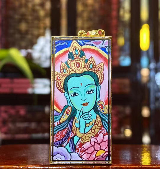 Front view of a double-sided Green Tara Thangka pendant, hand-painted with 18K gold in Rebgong tradition, depicting Green Tara in a youthful form holding the utpala lotus.