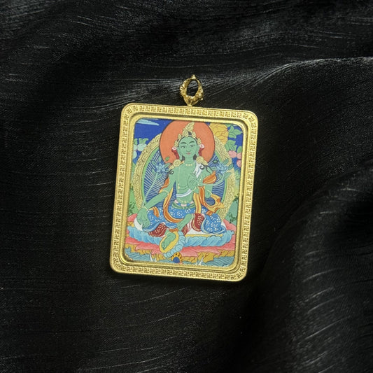 Green Tara Tibetan thangka pendant showing detailed hand painted Buddhist iconography, miniature portable thangka artwork from Tibet.