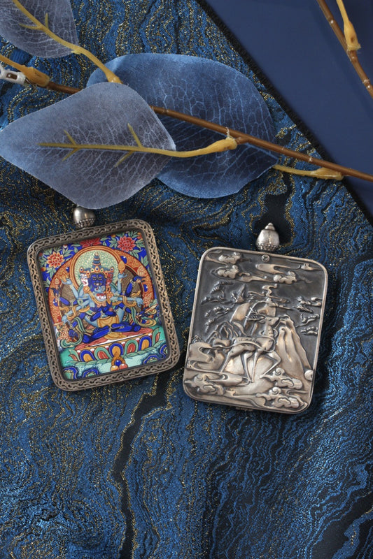 Front and back display of a Guhyasamāja Vajra mini thangka pendant, showing the hand-painted thangka panel on the front and the engraved pure silver back plate with Dunhuang-inspired motif details.