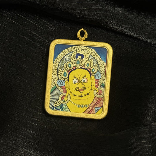 Angled view of Yellow Jambhala mini thangka pendant showing detailed mineral pigment painting and decorative copper pendant border