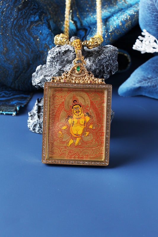 Close-up of the Yellow Jambhala figure painted in Rebgong gold thangka style, highlighting fine line work, mineral pigments, and traditional Tibetan iconographic proportions.