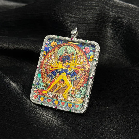 Front view of Kalachakra mini thangka pendant hand-painted with mineral pigments in a silver case, Rebgong thangka tradition
