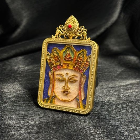 Angled close-up of Ksitigarbha Bodhisattva cloisonné enamel pendant showing gold wire cloisonné structure, colorful crown design, and gold-plated copper protective frame