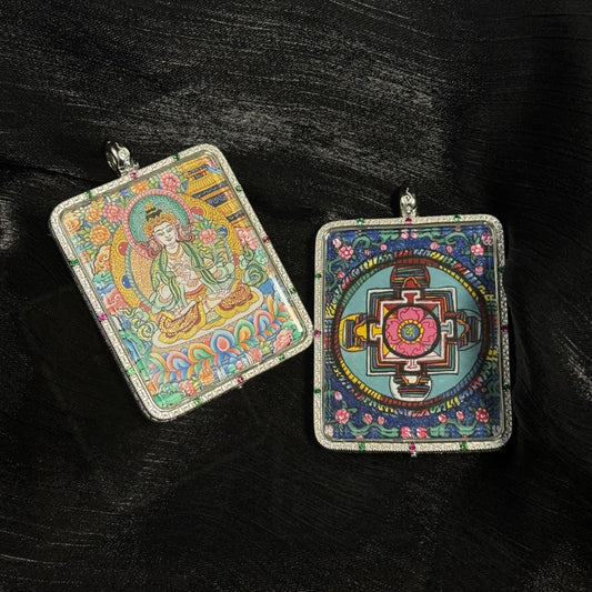 Front and back view of a Mahasthamaprapta Bodhisattva mini thangka pendant, showing the hand-painted bodhisattva seated on a lotus throne and a sacred mandala design on the reverse, enclosed in a square 925 sterling silver pendant case with colored gemstone accents.