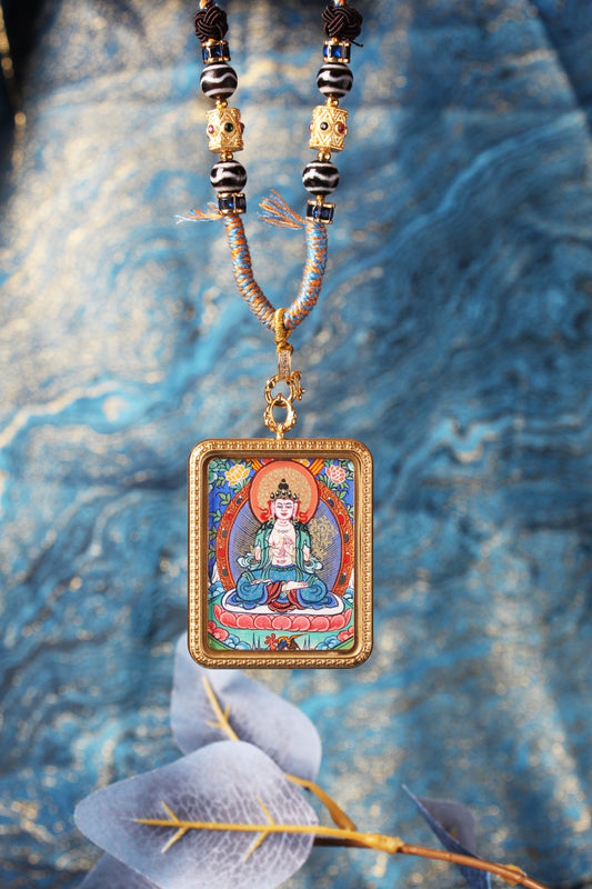 Close-up front view of Mahasthamaprapta Bodhisattva mini thangka pendant, featuring vivid mineral pigment painting inside a titanium steel frame with gold-tone clasp and bead details.