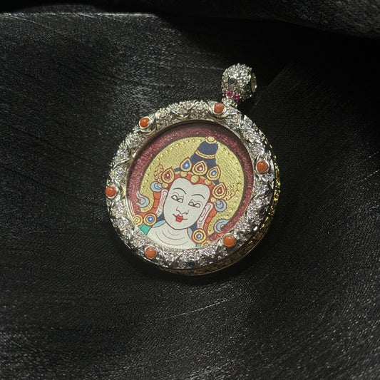 Angled view of Mahasthamaprapta Bodhisattva miniature thangka pendant highlighting pure gold halo painting, cinnabar background texture, and decorative jeweled copper pendant frame