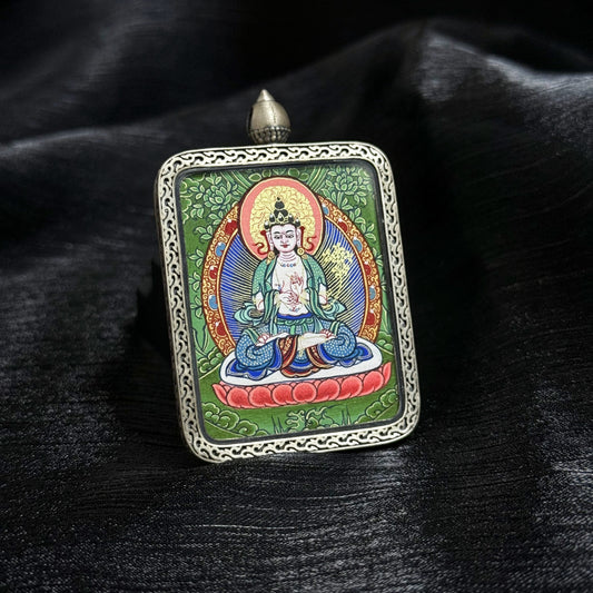 Close-up of Mahasthamaprapta Bodhisattva mini thangka pendant showing detailed Rebgong mineral pigment painting and ornate silver pendant frame