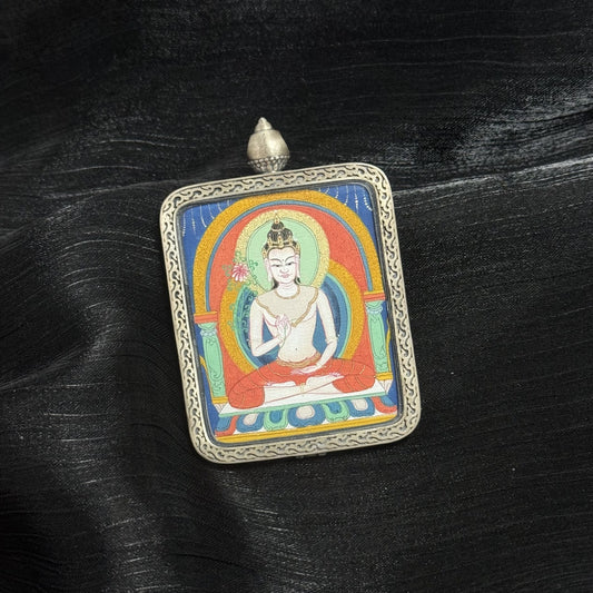 Close view of Mahasthamaprapta Bodhisattva miniature Tibetan thangka pendant, hand painted Buddhist sacred art with traditional mineral pigment style.