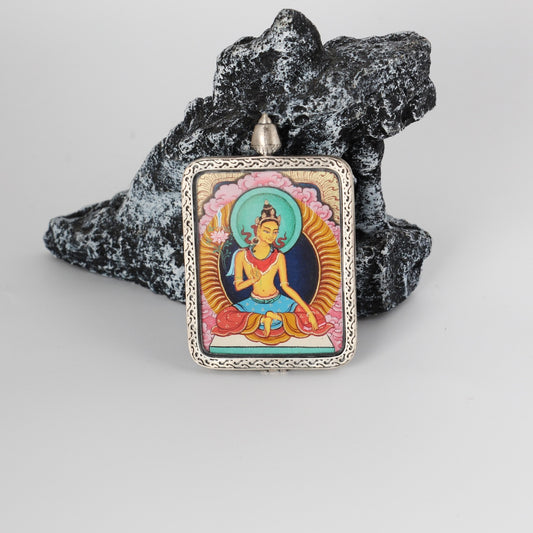 Front view of a Manjushri Bodhisattva mini Thangka pendant, fully hand-painted with mineral pigments and framed in a pure silver gawu-style pendant case with traditional Tibetan decorative patterns.
