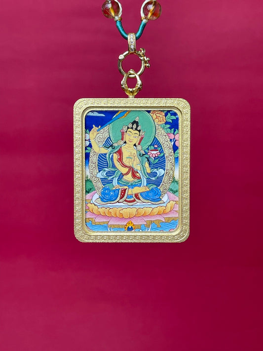 Hand-painted Manjushri Bodhisattva mini thangka pendant with mineral pigments, Tibetan sacred artwork in textured copper frame showing wisdom sword and lotus iconography