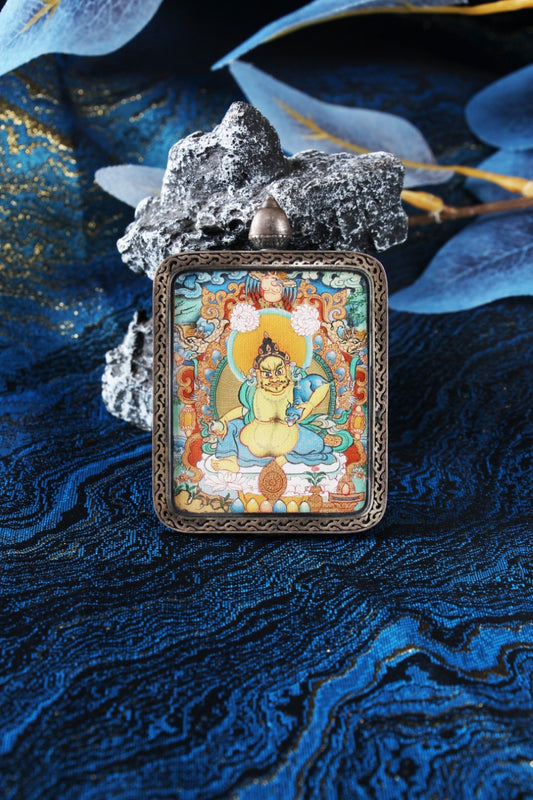 Menri style Yellow Jambhala thangka pendant from Tibet, hand-painted with natural mineral pigments, symbol of wealth, prosperity, and abundance