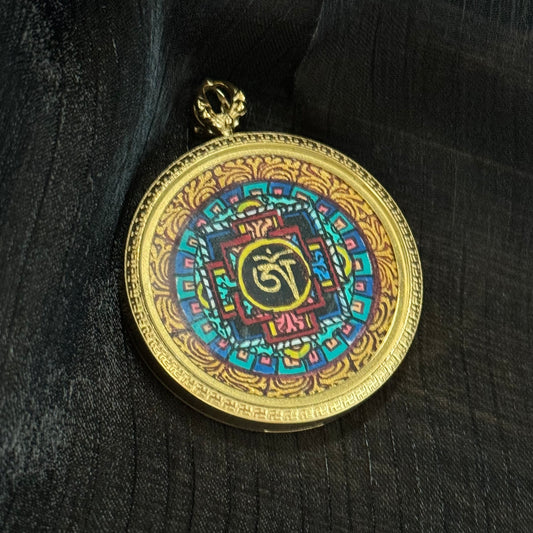Close-up of Nepal hand-painted mandala miniature thangka pendant showing colorful Buddhist sacred geometry with traditional mineral pigment details inside round pendant frame