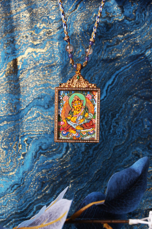 Mini Nepal-style Yellow Jambhala thangka pendant with ornate gold frame, symbol of wealth and prosperity in Tibetan Buddhism