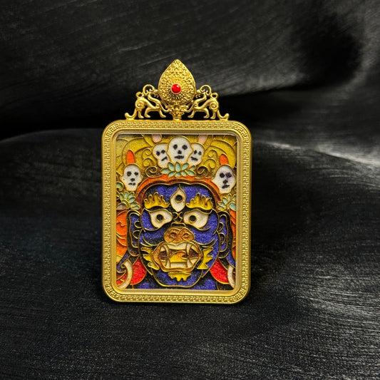 Front view of a Palden Lhamo cloisonné enamel mini thangka pendant with a 24K gold-plated copper frame, colorful deity face details, and ornamental top element.