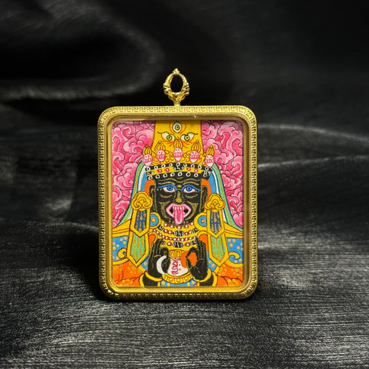 Front view of pink Zaki Lhamo mini thangka pendant hand painted in Nepal featuring vivid mineral pigment colors, expressive deity face, ornate crown and gold framed portable Tibetan Buddhist artwork.