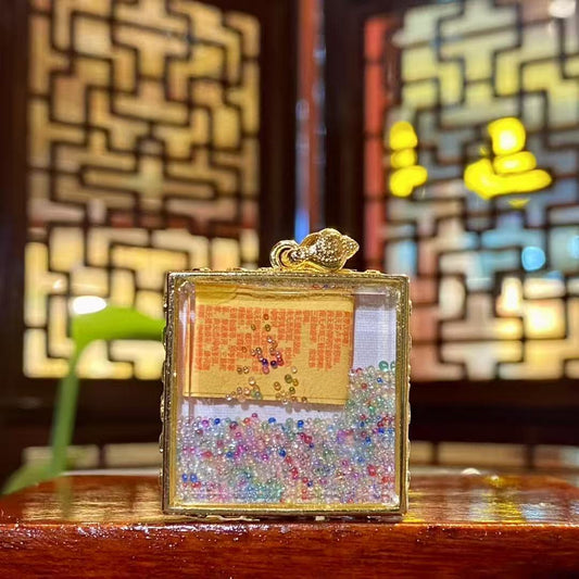 Back view of Samantabhadra Bodhisattva mini thangka pendant with seven treasures glass bead inside the Tibetan Gawu box