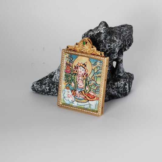 Angled view of the Samantabhadra Bodhisattva mini thangka pendant highlighting the crystal-set border, gold-tone titanium steel case depth, and the ornate crown top with green and multicolor stones, with the hand-painted elephant and bodhisattva artwork visible through the front window.