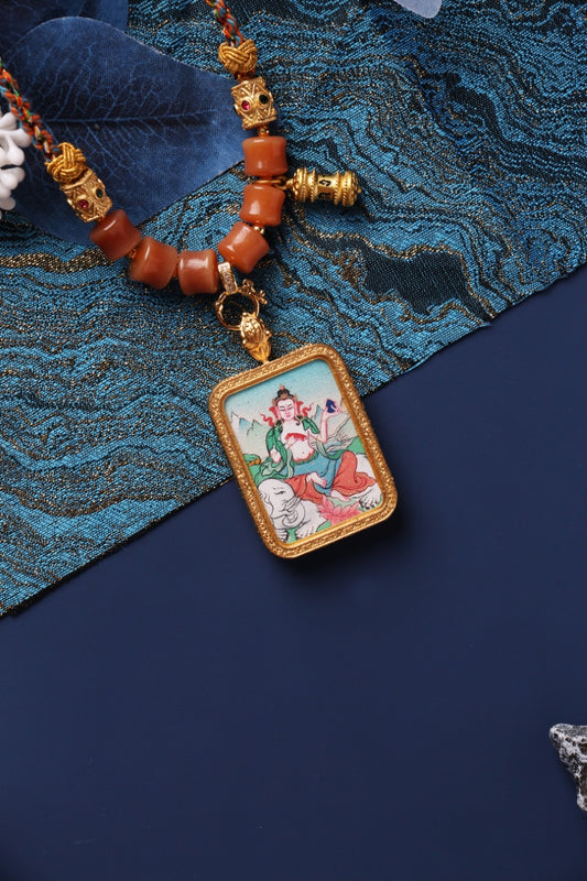 Close-up of Samantabhadra Bodhisattva mini thangka pendant, hand-painted with mineral pigments and set in a double-sided titanium steel frame, displayed with traditional beaded necklace