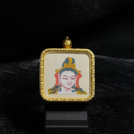 Front view of a Samantabhadra Bodhisattva mini thangka pendant showing a hand-painted Tibetan deity portrait on canvas inside a square gold-toned ornamental pendant frame.
