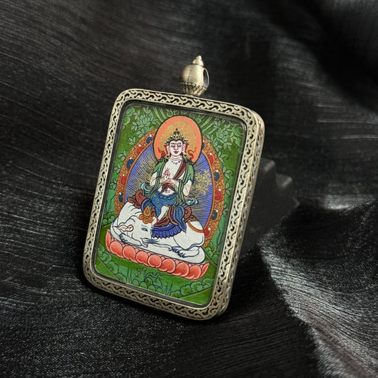 Angled view of Samantabhadra Bodhisattva mini thangka pendant highlighting detailed Tibetan hand-painted thangka art and ornate metal pendant frame