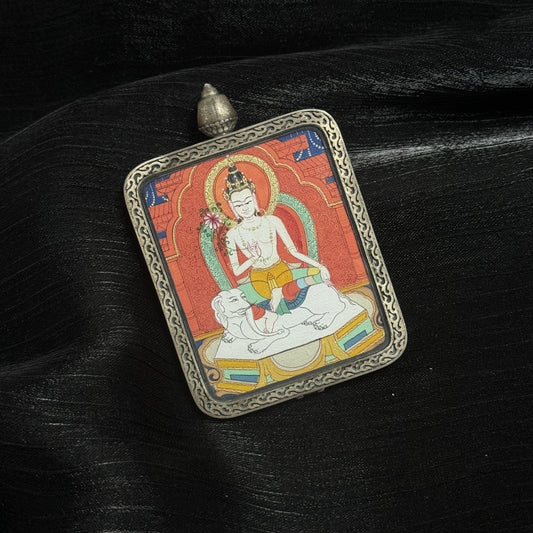 Angled view of Samantabhadra Bodhisattva miniature thangka pendant, Tibetan Buddhist hand-painted thangka set in engraved silver protective case