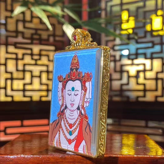 Side view of a Vairocana Buddha mini thangka pendant showing the gold-plated copper Gawu box craftsmanship