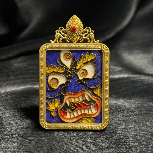 Front view of Six-Armed Mahakala cloisonné enamel mini thangka pendant showing detailed wrathful protector mask design with blue enamel background and 24K gold-plated copper frame